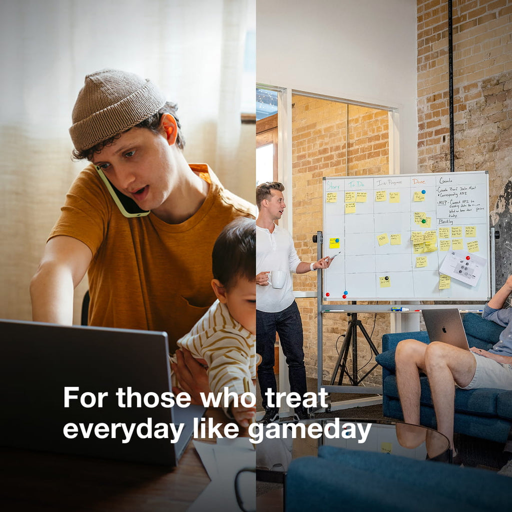 A young man sitting at his desk with his phone to his ear and a young child in his lap. A work environment with someone pointing to a whiteboard with sticky notes on it and a group of people listening. For those who treat everyday like gameday.