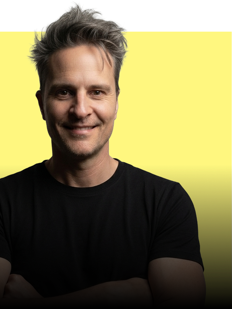 Man wearing a black shirt against a yellow background